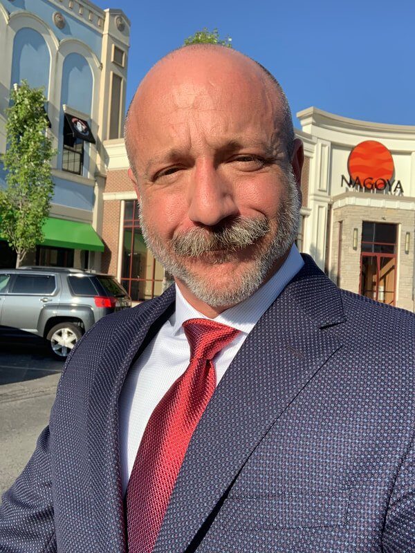 Dr. Barclay Barrios headshot, wearing a suit.